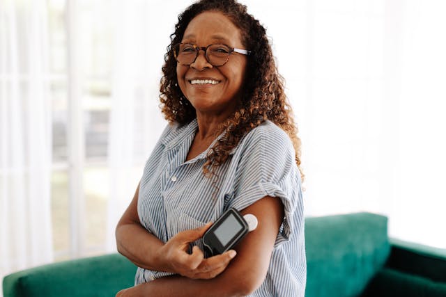 Senior woman using a flash glucose monitor to manage her diabetes at home | Image Credit: (JLco) Julia Amaral - stock.adobe.com